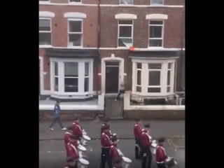 Nothing Makes Sense Anymore: Man Launches Trash Can at Marching Band