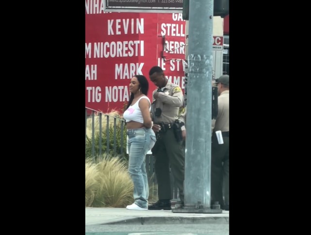 I Wonder Why This Officer Is Taking His Sweet Time Putting Those Handcuffs On Her