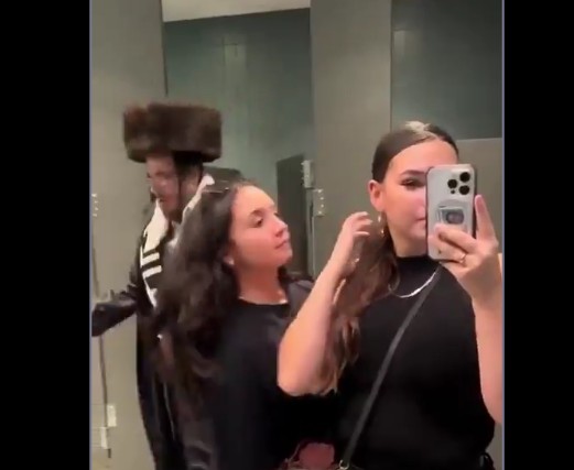 Creep! A Man Wearing An Extremely Large Fur Hat Was Captured Using The Ladies Bathroom.